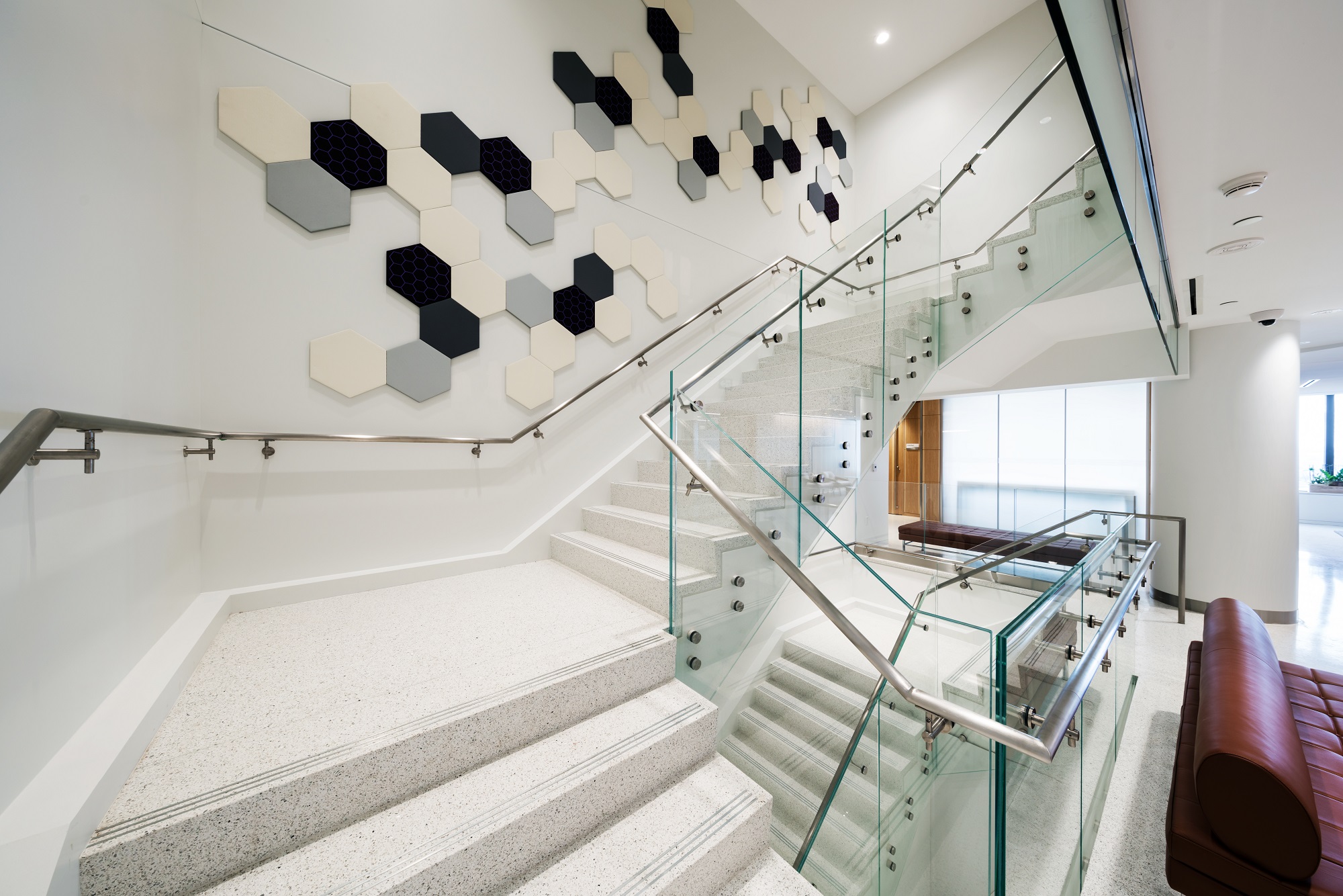 Elegant interior staircase highlighted by framed glass railing by Raw Glass, installed in Ottawa