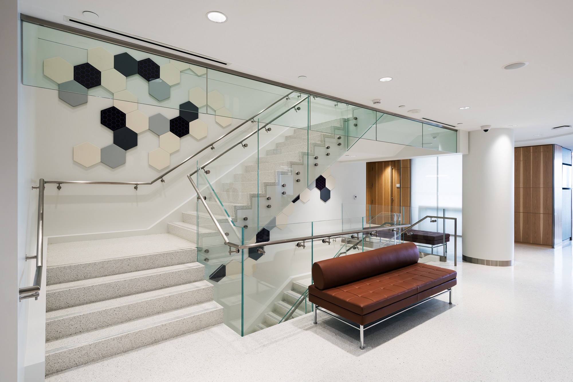 Elegant interior glass railing in a modern setting, fabricated and installed by Raw Glass Inc.