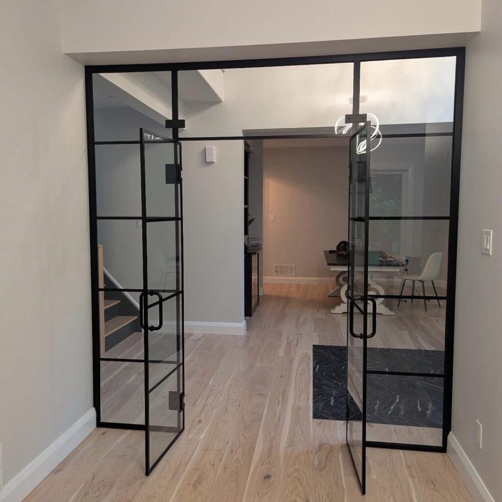 Residential interior mullion glass door and partition, framed in black metal, installed by Raw Glass in Ottawa