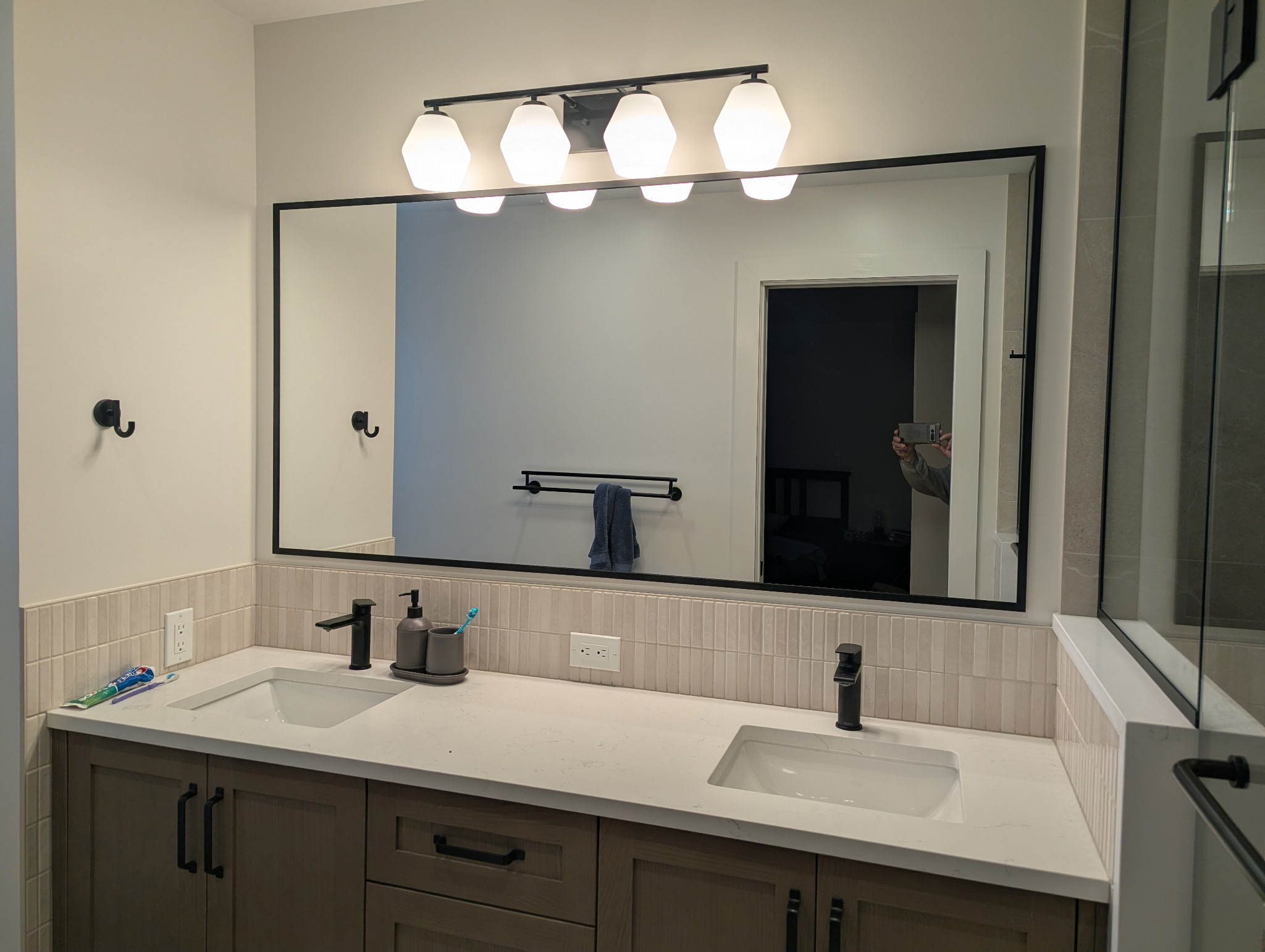 Decorative bathroom mirror over double sinks, fabricated and installed in Ottawa by Raw Glass