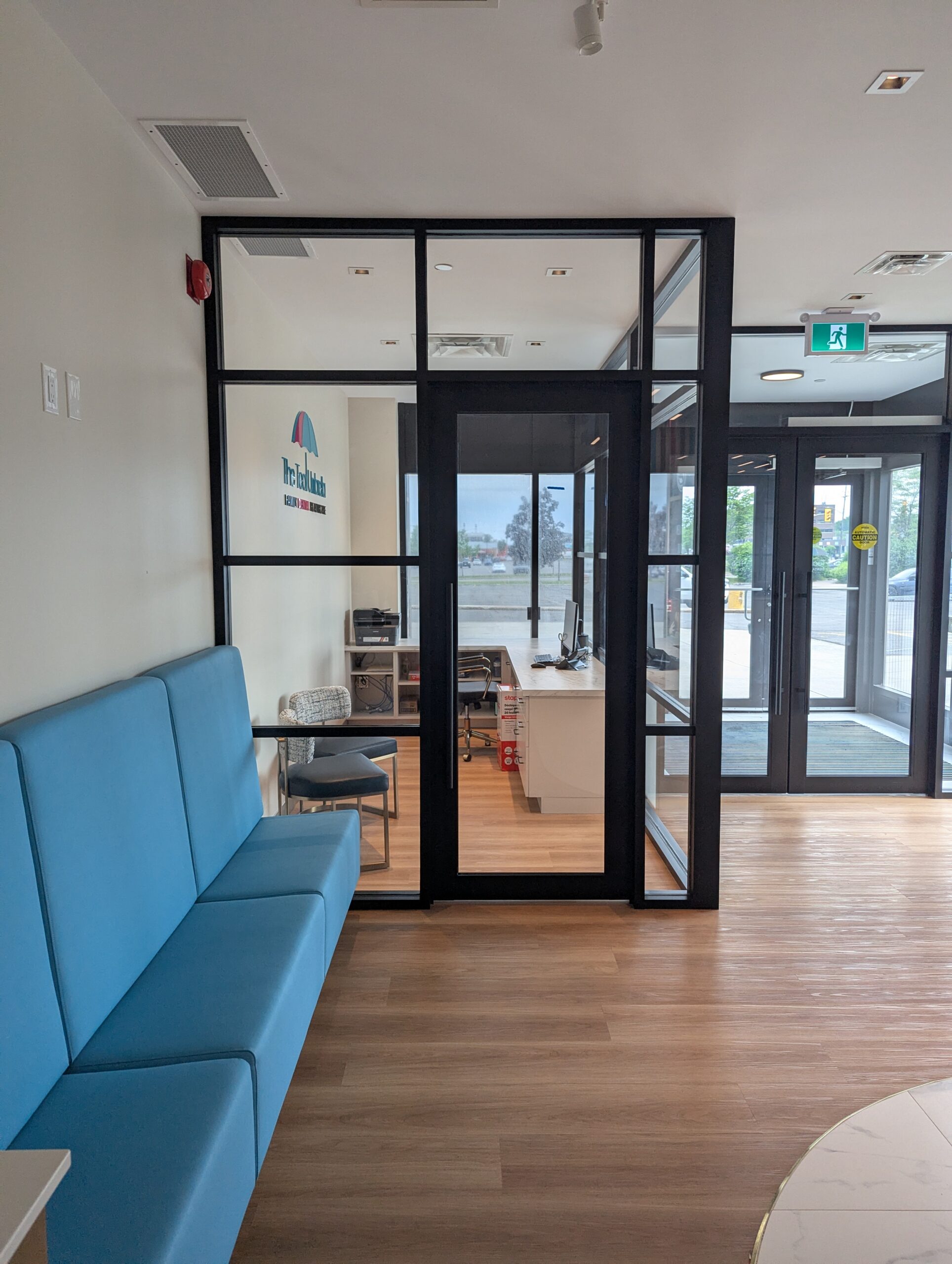 Glass partition providing privacy for office space at Ottawa dental clinic, fabricated and installed by Raw Glass